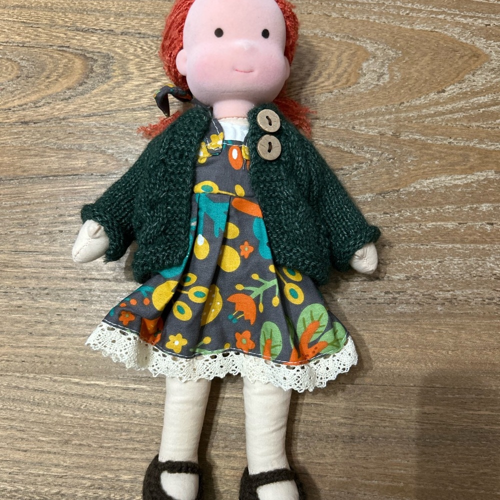 Charming Doll with Dark Green Sweater and Floral Dress